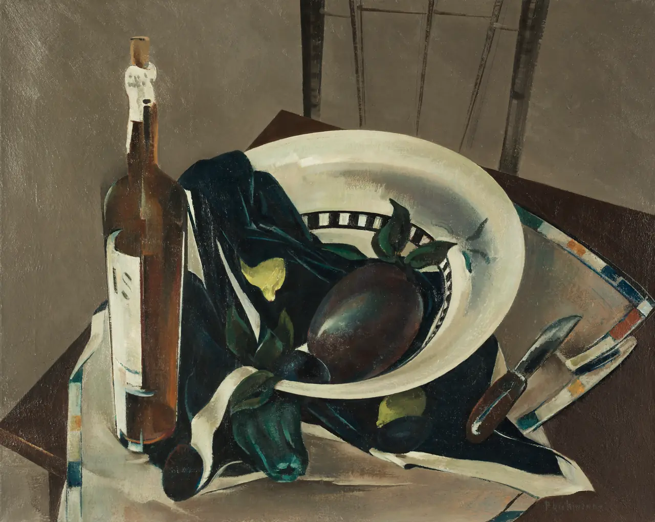 A brown bottle and a white bowl with eggplants and lemons sit on dark cloth beside a knife and an empty chair.