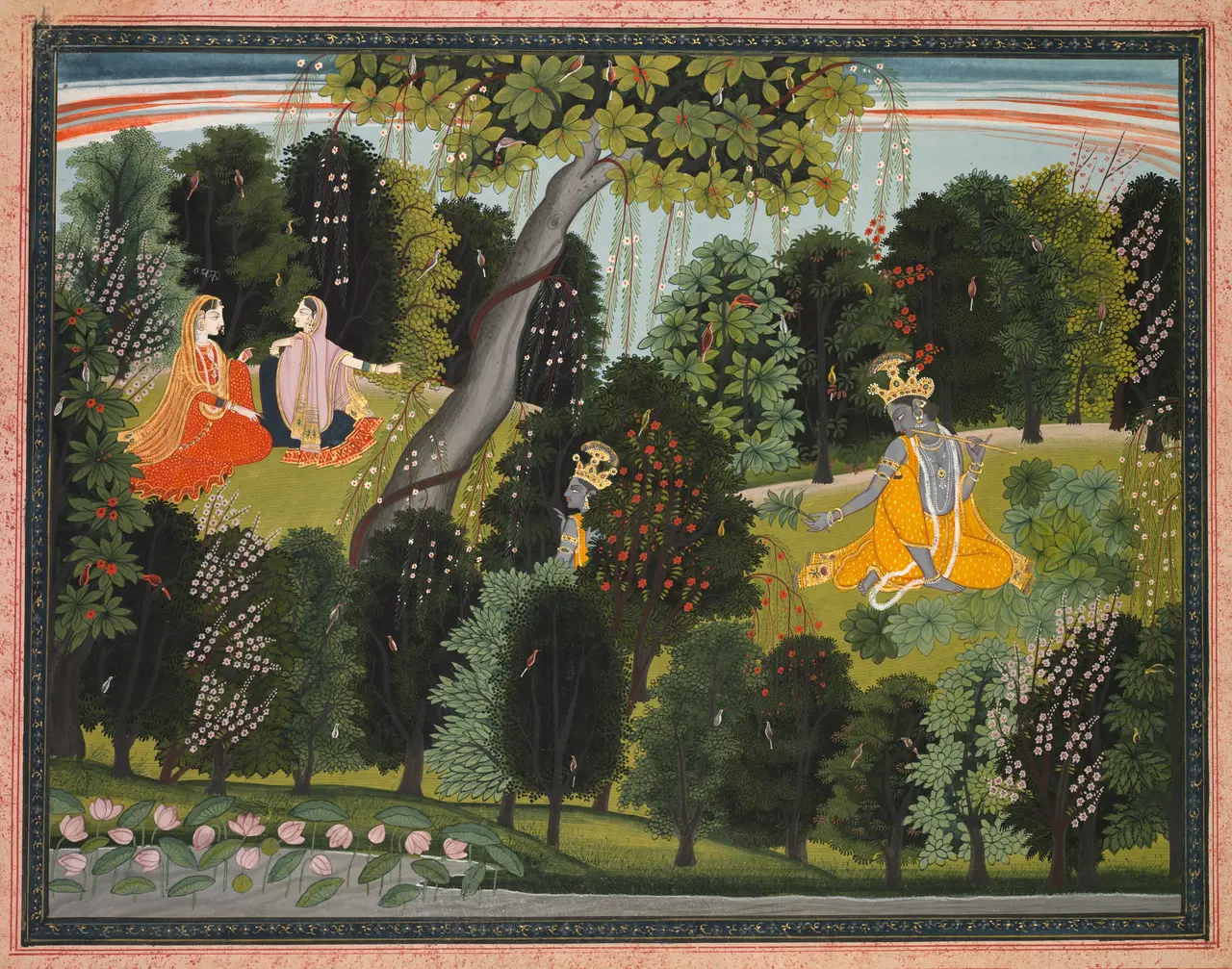 Two women sit in a dense flowering forest at upper left while the blue-skinned Krishna appears twice at right, once behind a flowering shrub and once playing a flute above a river lined with lotus buds.