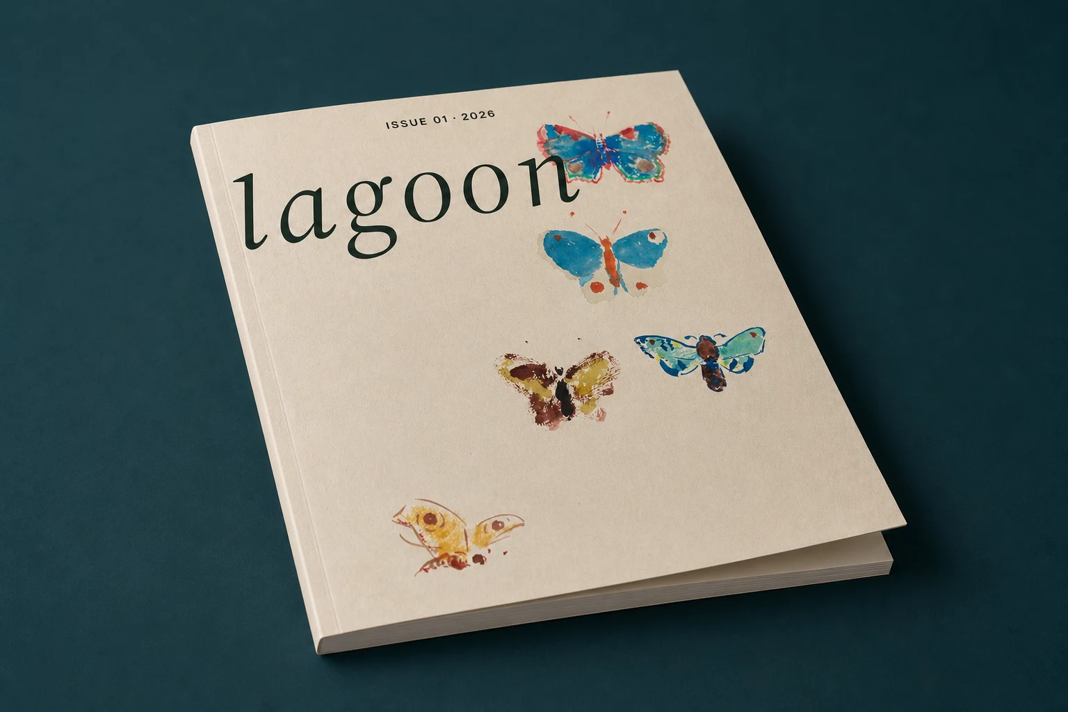 Lagoon Issue 01 lying on a deep blue-green surface with its front cover slightly open